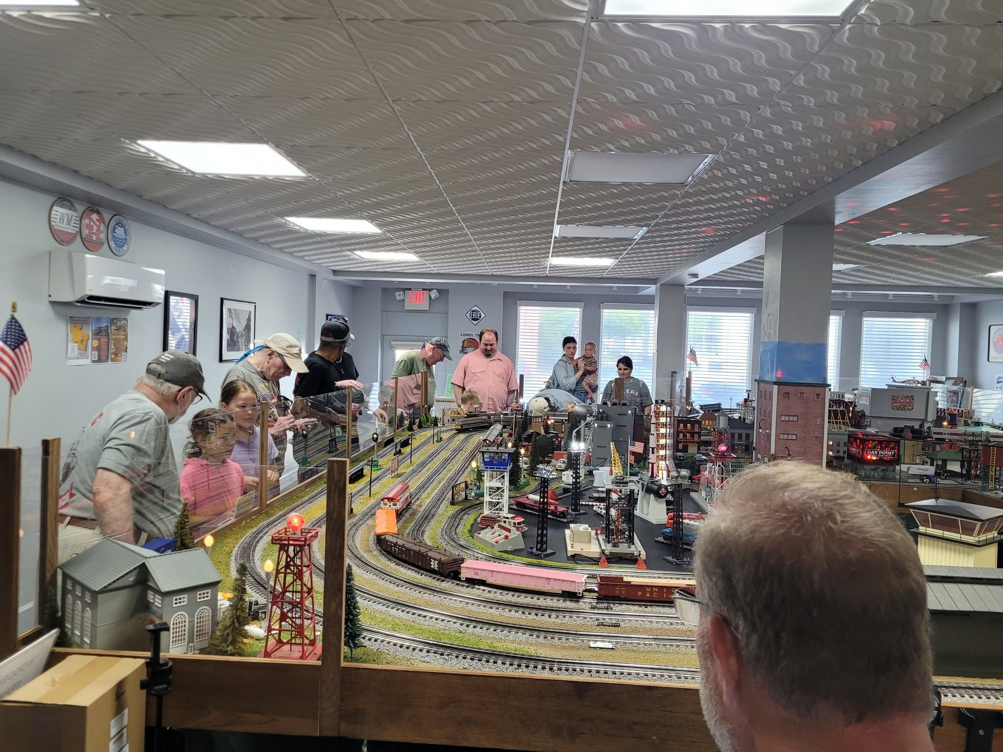 Model railroad rural landscape with farms, fields, and a country road crossing